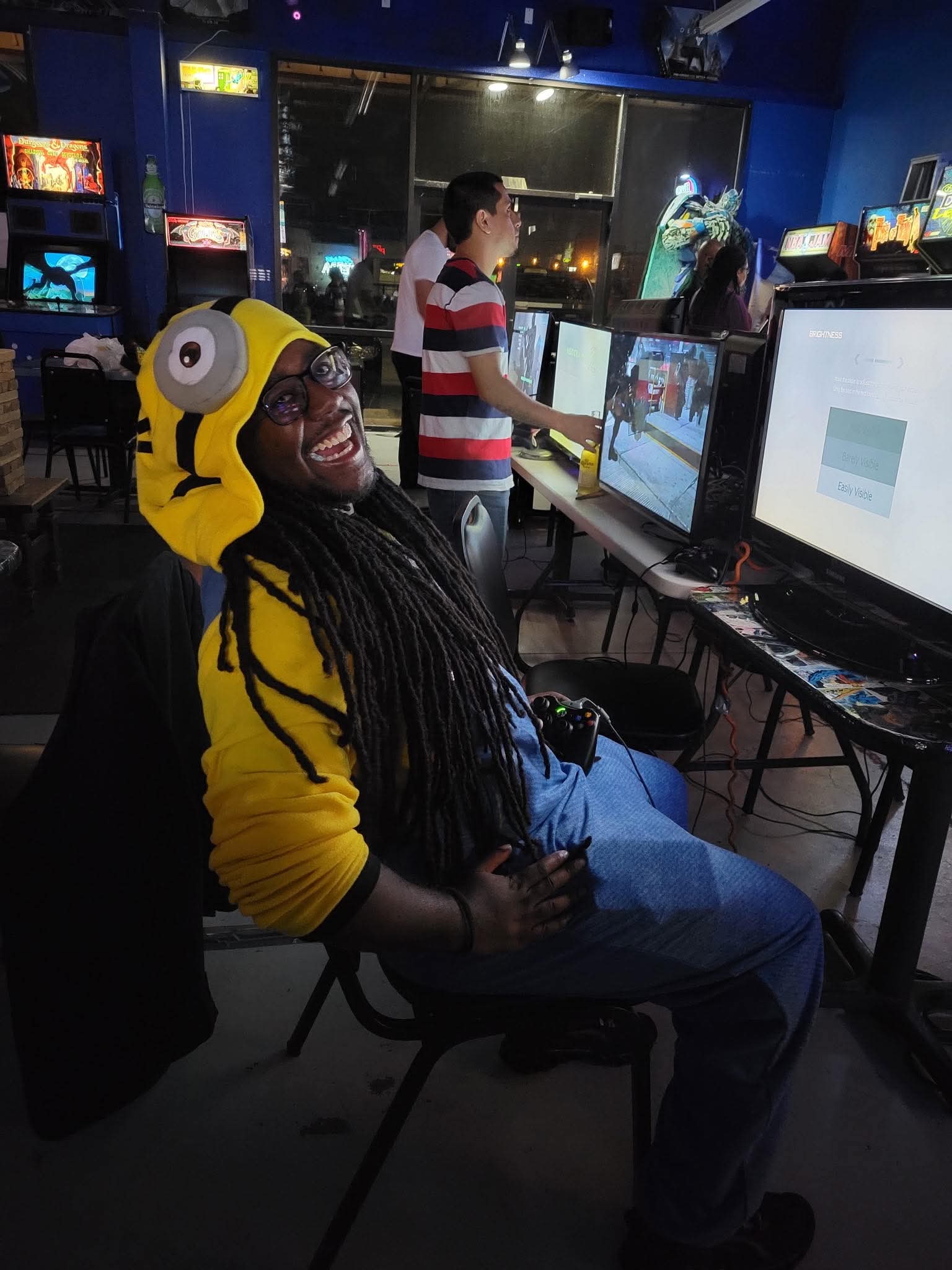 Yanonick smiling in a Minion outfit at an arcade